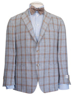 The Samuelsohn Super Light Blazer, a light blue and tan plaid masterpiece, over a blue dress shirt paired with a brown patterned bow tie, showcases men's luxury clothing through its heritage authenticity and superior craftsmanship.