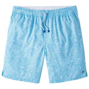 The Peter Millar Tropics Swim Trunk features a light blue color with a white drawstring and subtle palm tree print, made from four-way stretch fabric, shown laid flat on a white background.