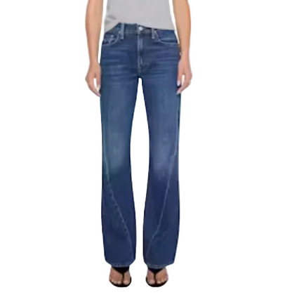 A person wearing Mother’s The Bookie Twist Skimp bootcut jeans in a light blue wash and black open-toe sandals, standing against a plain light background.