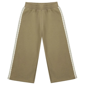 The Girls’ Wide Leg Sweat Pant by Rylee & Cru features a relaxed fit in khaki with an elastic waistband and delicate white lace trim along the sides.