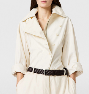 A person wears the Stella McCartney Washed Cotton Utility Top in cream with rolled-up sleeves, paired with a black woven belt and matching cream trousers.