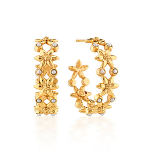 The Juliska Capucine De Wulf Jasmine Hoop Earrings feature a delicate jasmine blossom design with small pearl accents, shown against a white background.