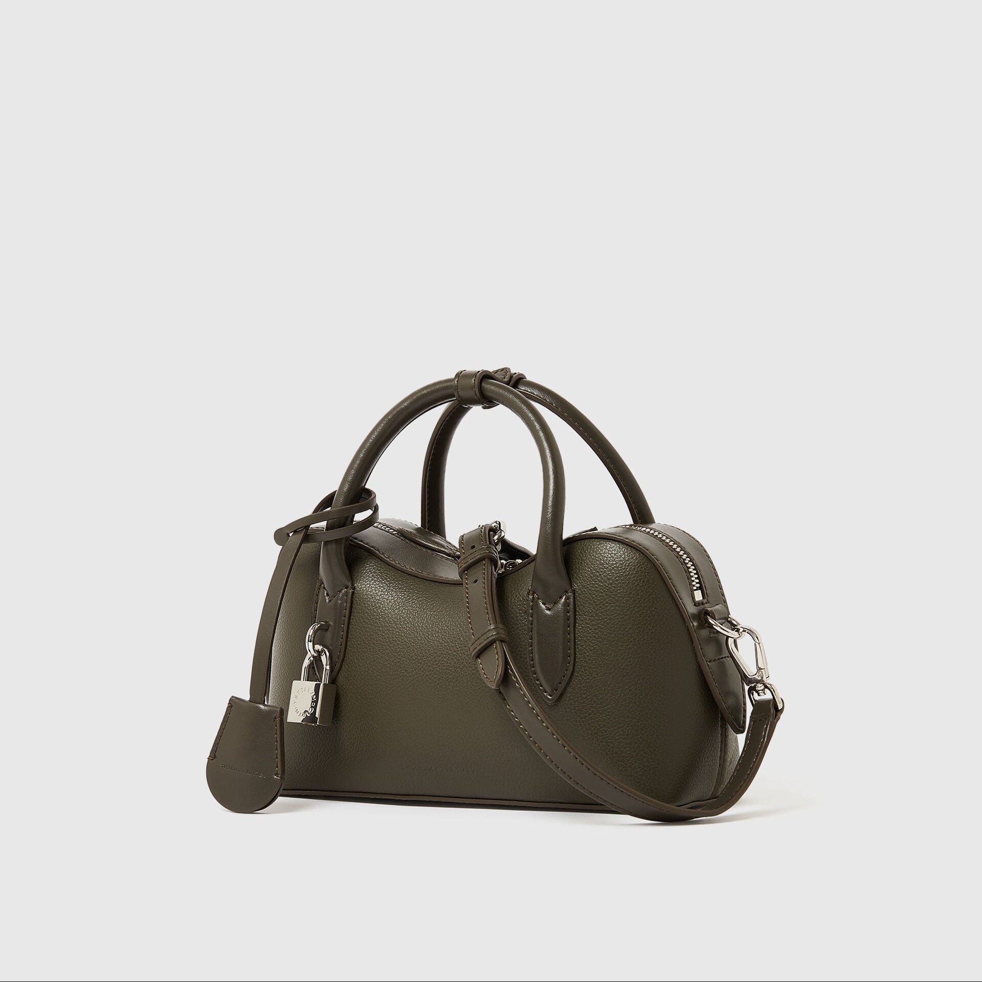 The Ryder Crossbody Bag by Stella McCartney is a small, olive green, Italian handcrafted bag with double handles, detachable shoulder strap, silver hardware, and padlock accent—cruelty-free and set against a white background.