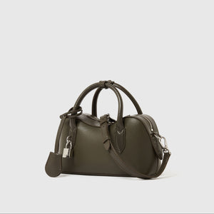 The Ryder Crossbody Bag by Stella McCartney is a small, olive green, Italian handcrafted bag with double handles, detachable shoulder strap, silver hardware, and padlock accent—cruelty-free and set against a white background.