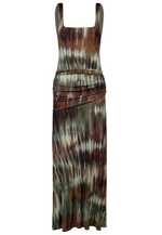 The Pine Green Plant of Joy Ankle Dress by Johanna Ortiz is a sleeveless, shiny jersey dress featuring a square neckline, ruched hip detail, and a brown, green, and white tie-dye pattern.