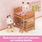 Two toy rabbits stand beside wooden bunk beds with ladders—a delightful Children’s Bedroom Set from Calico Critters—featuring mattresses and blankets, all in a pink room adorned with floral wallpaper and a window, making it ideal for dollhouse furniture fans.