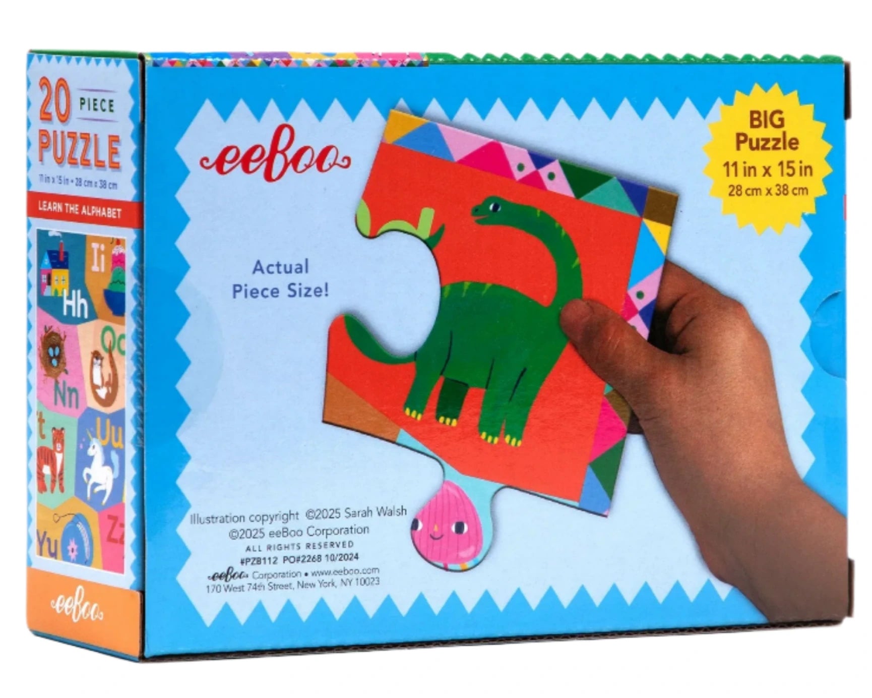 A box of Eeboo’s Learn the Alphabet 20 Piece Puzzle, showing ABC-themed pieces with a hand holding a green dinosaur puzzle piece and the actual size displayed.
