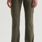 A person is wearing the Everett Slim Straight pants by AG Jeans in olive green, styled with a gray shirt and light beige sneakers, standing against a plain light background.