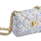 Milledeux Small Chain Bag in Liberty Print with gold chain strap and quilted flap closure on a white background.