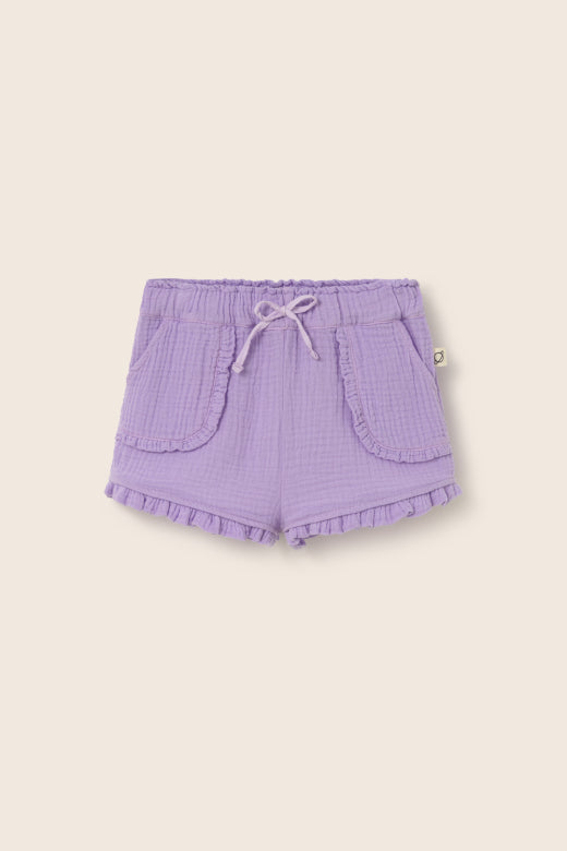 Cozmo Baby Girls' Stella Ruffle Shorts feature a light purple hue, drawstring waistband, front patch pockets, and ruffle hem—cute and comfy toddler shorts shown on a plain beige background.
