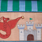 An illustrated red dragon stands before a gray castle adorned with a green flag, all set against a backdrop reminiscent of the intricate patterns found in Rice's handmade Raffia Toy Baskets.