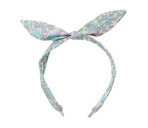The Girls' Lorette Headband by Bonpoint features a pastel floral print and two pointed ends tied at the top like bunny ears, creating an adorable accessory perfect for charming everyday style.