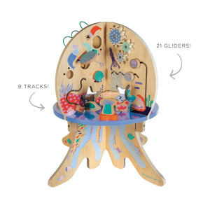 A colorful Manhattan Toy Deep Sea Adventure featuring 21 gliders and 9 tracks, designed to look like a jellyfish with various sea creatures and interactive elements, coated in non-toxic water-based finishes.