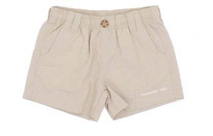 The Boys' Mallard Short by Properly Tied is beige cotton with an elastic waistband, quick-dry fabric, side pockets, a front button, and "PROPERLY TIED" printed on the lower front.