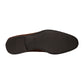The image shows the bottom view of Magnanni’s Destin Cognac Suede dress shoe, featuring a comfortable black rubber sole with textured areas at the heel and toe.