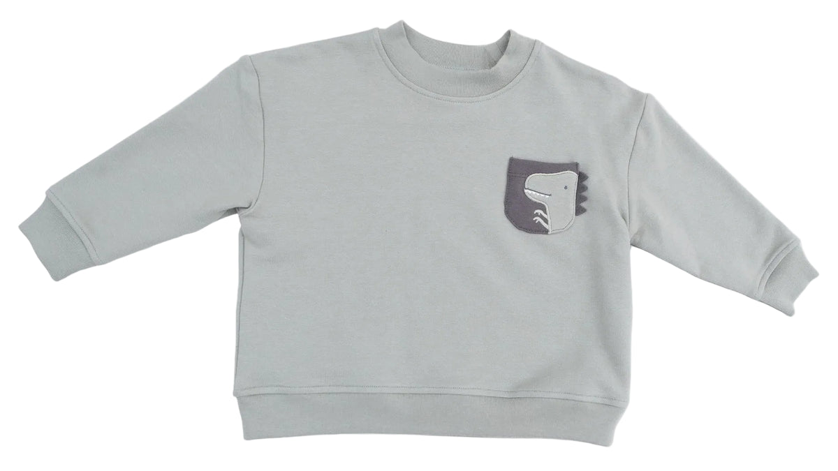 The Angel Dear Baby and Kids’ Drop Sleeve Sweatshirt is a light gray, long-sleeve top made from soft organic french terry, featuring a small chest pocket adorned with a simple dinosaur graphic.
