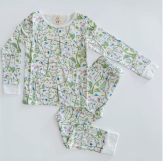 Kids' The Two Piece Pajamas by Timo & Violet, made from soft organic cotton, feature a white base with a colorful floral and botanical pattern and are shown laid flat on a white surface.