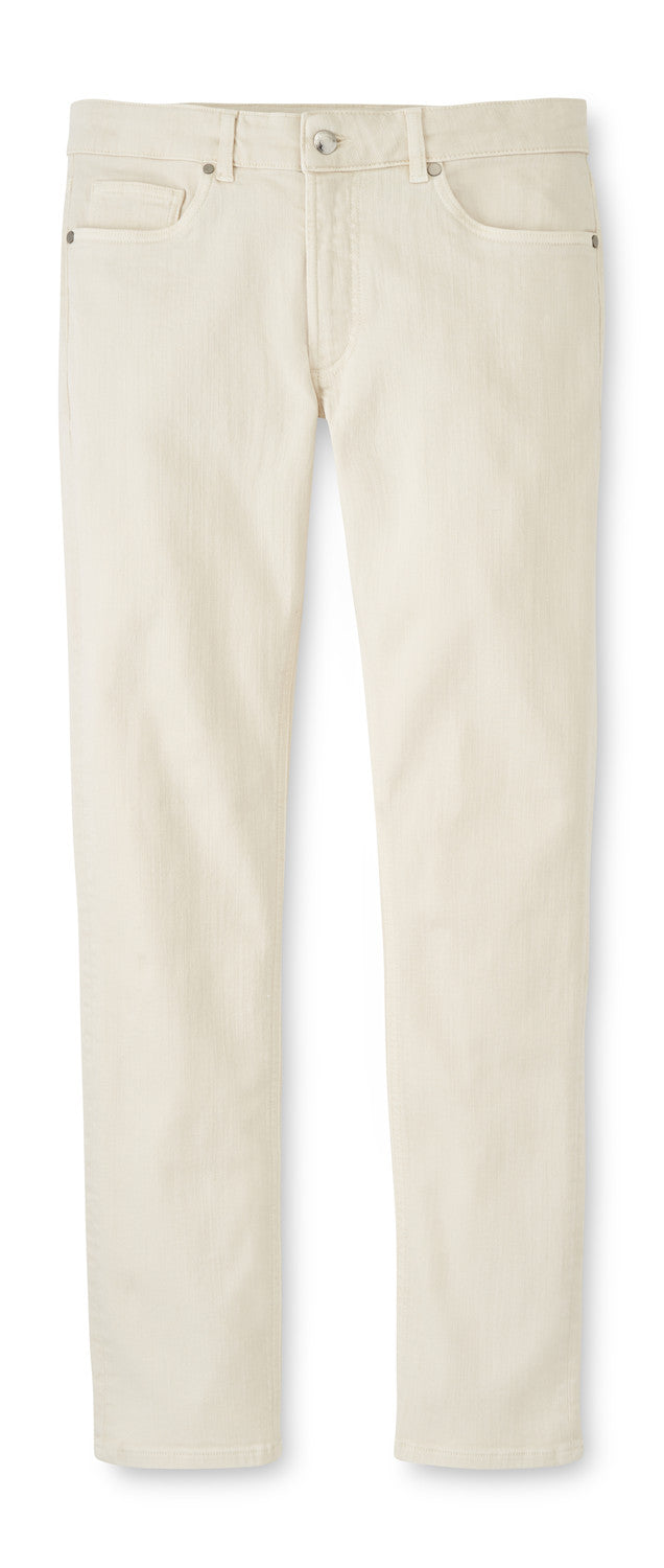 The Peter Millar Fairfield Garment Dyed Denim jeans feature a straight-leg, light beige cotton-stretch fabric, front and back pockets, button closure, and belt loops—laid flat on white; versatile for three-season casual wear.