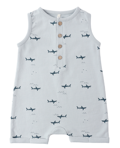 The Rylee & Cru Baby Boys' Davis Romper is a sleeveless light blue coastal piece featuring playful sharks, three wooden chest buttons, and a round neckline.