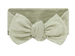 Lou Lou & Company Baby Girls’ Collins Plush Knit Headband in light green features a large, knotted bow at the front, making it a charming hair accessory for toddlers, shown against a white background.