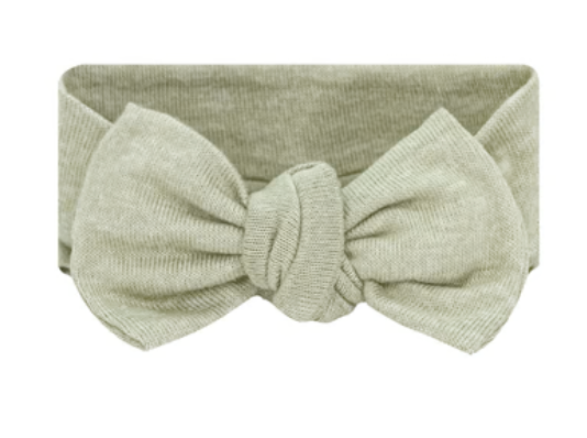 Lou Lou & Company Baby Girls’ Collins Plush Knit Headband in light green features a large, knotted bow at the front, making it a charming hair accessory for toddlers, shown against a white background.