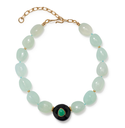 The Andalusia Collar by Lizzie Fortunato is a beaded necklace with pale green oval beads, gold spacers, a gold chain clasp, and a black circular pendant featuring green chrysoprase.