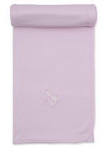 The Kissy Kissy Giraffe Laughs Blanket is a light pink Pima cotton baby blanket featuring scalloped edges and an embroidered giraffe design near the center, shown partially rolled at the top.