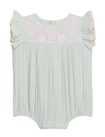 The Louise Misha Baby Girls’ Nusha Romper features light green cotton gauze with short ruffle sleeves, pink floral embroidery on the chest, and gathered fabric detailing.