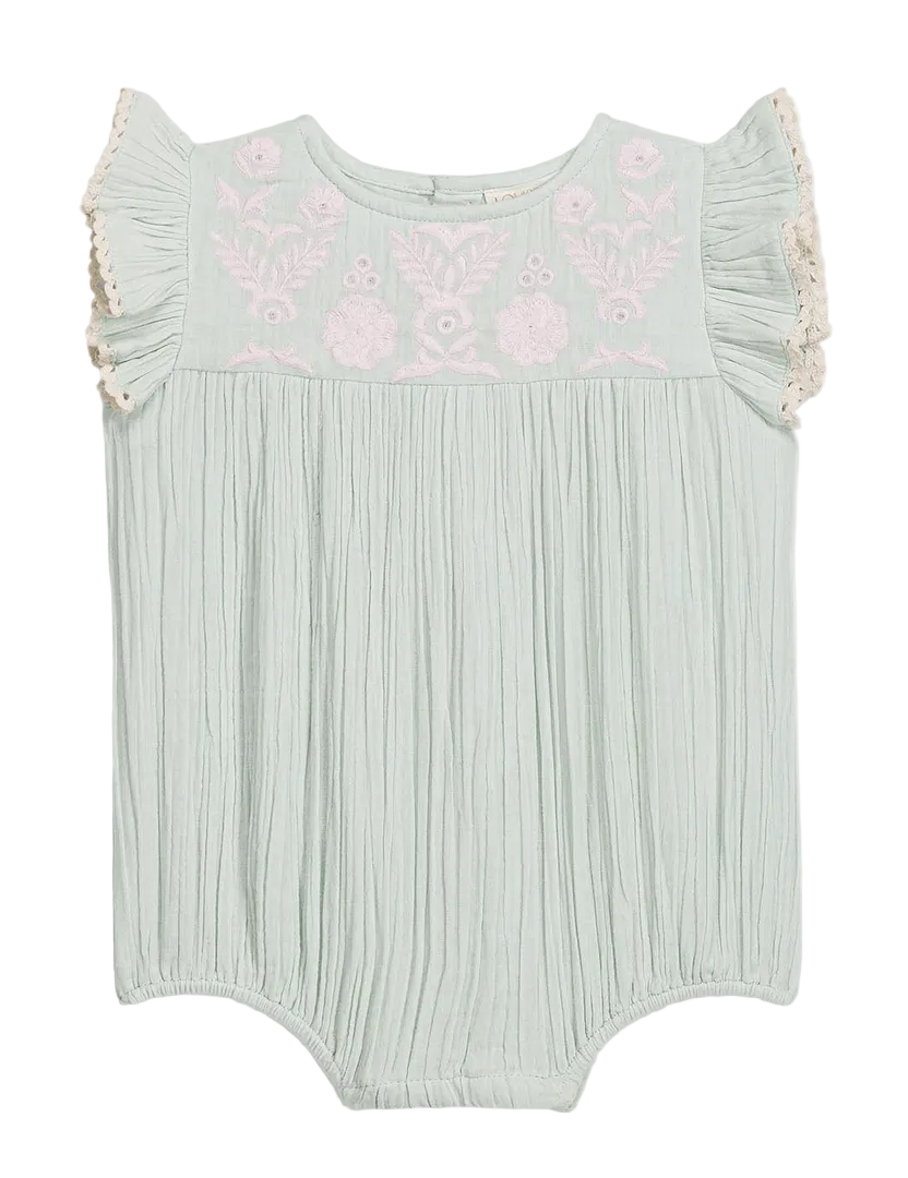 The Louise Misha Baby Girls’ Nusha Romper features light green cotton gauze with short ruffle sleeves, pink floral embroidery on the chest, and gathered fabric detailing.