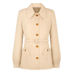 The Donzi Paint Jacket by Blaze Milano is a beige belted jacket with button closure, large collar, long sleeves, and two front flap pockets—a modern update of the classic hunting jacket inspired by Blaze Milano’s signature style.