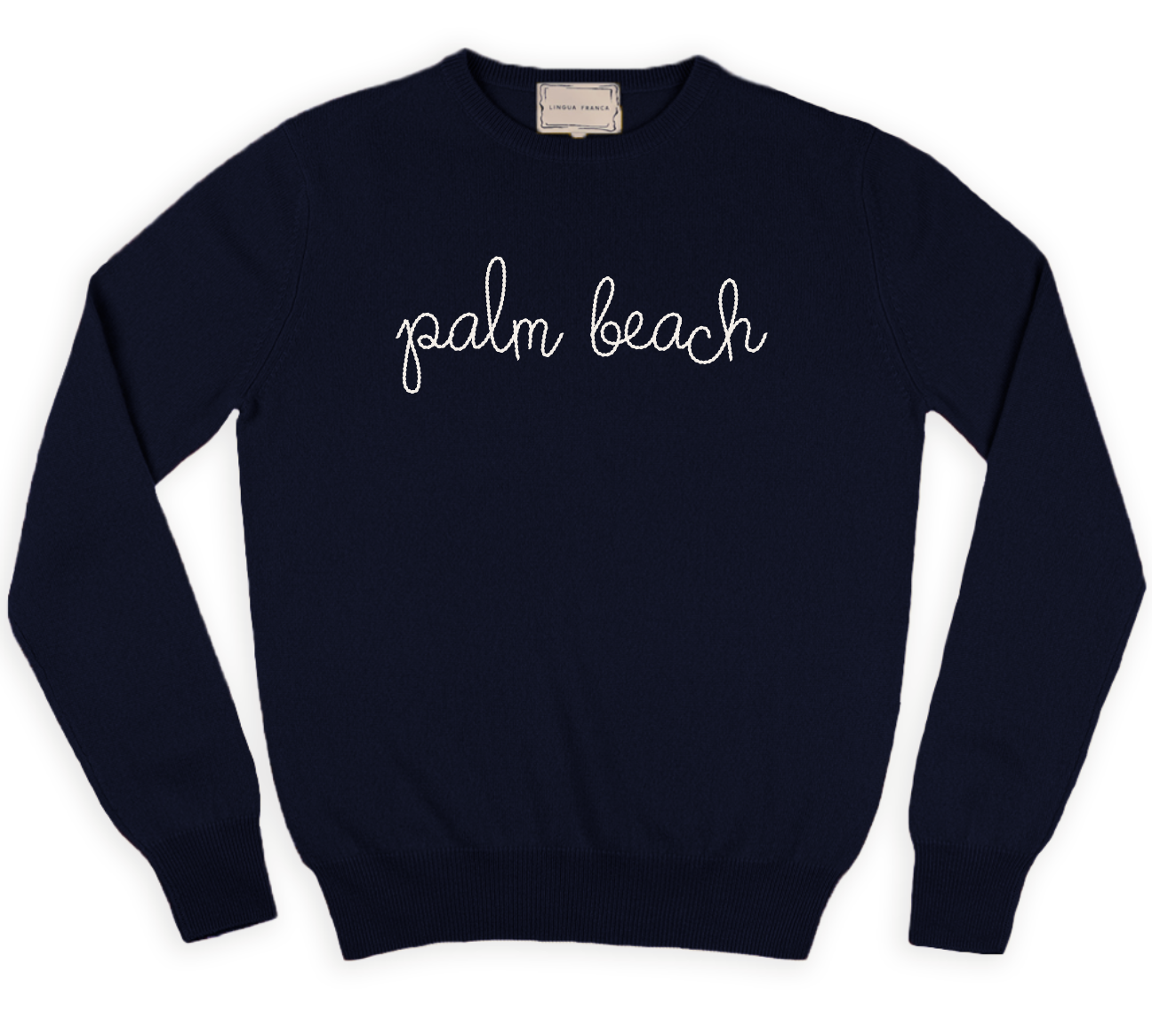 A Lingua Franca navy blue classic longsleeve crewneck with "palm beach" in cursive white letters on the front, crafted from sustainably sourced materials.