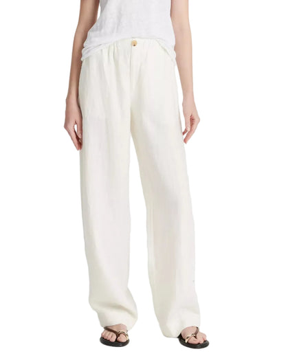 A person wears Vince's Hemp Utility Pant—breathable, loose-fitting white linen—with a sleeveless top and black sandals, creating a relaxed silhouette against a plain background.