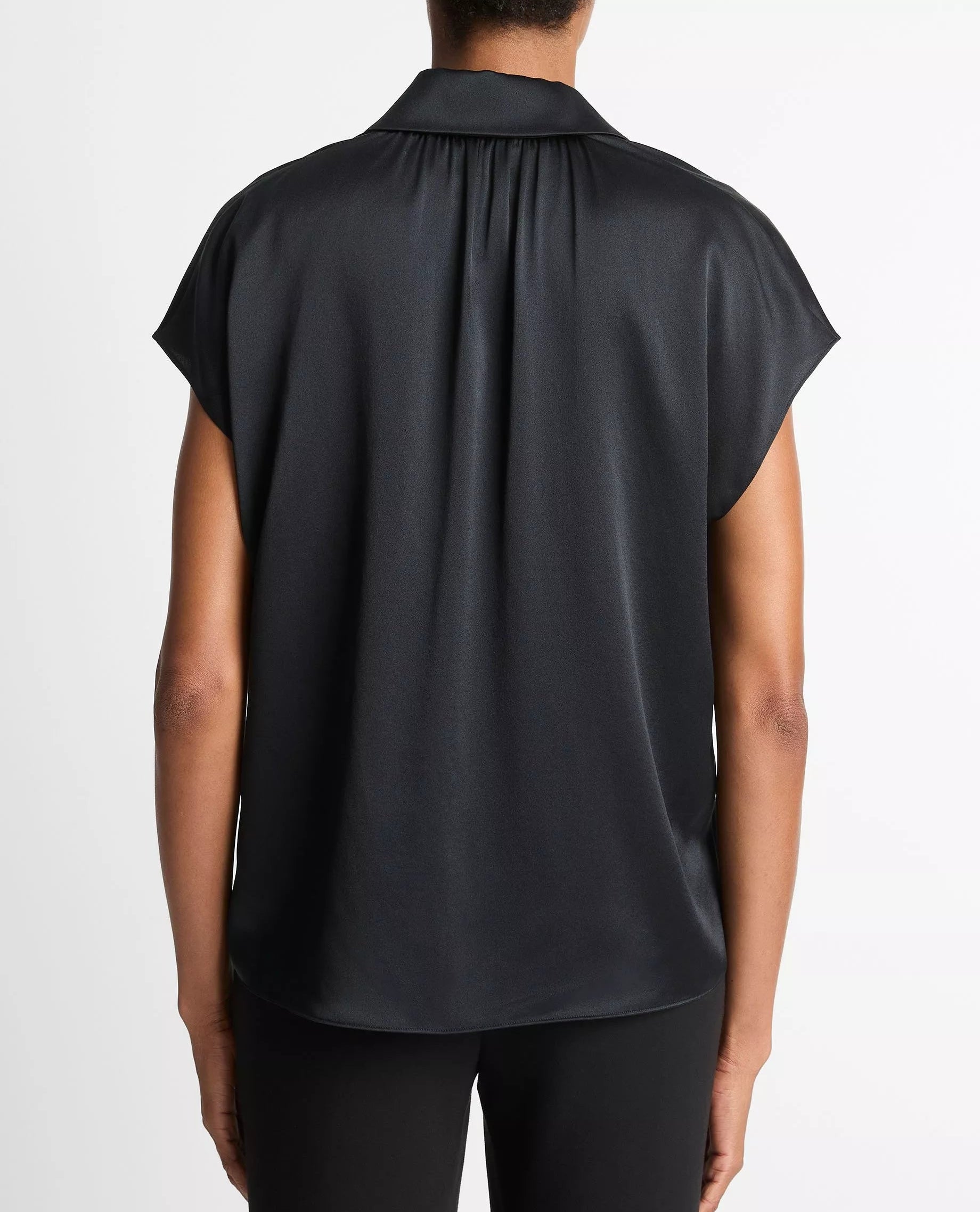 A person is shown from the back wearing the vince Cap Sleeve Silk Blouse in black and black pants against a plain white background.