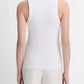 Seen from the back, the person is wearing the vince Ribbed Scoop Neck Tank—finely ribbed and sleeveless, crafted in a soft cotton modal blend—paired with light-colored pants against a plain background.