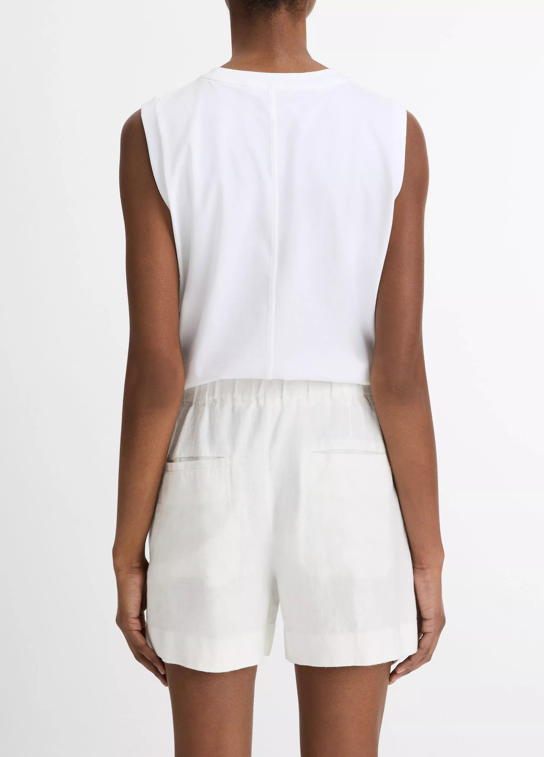 A person is shown from the back against a plain background, wearing a white sleeveless top and vince Mid Rise Hemp Shorts with a relaxed silhouette.