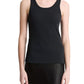A person wearing the vince Ribbed Scoop Neck Tank—a finely ribbed, black sleeveless top made from a soft cotton modal blend—paired with a black skirt and standing against a plain white background.