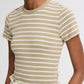 A model wears the vince Stripe Shrunken 90s Tee—a beige and white striped, shrunken-fit top—tucked into high-waisted, light-colored pants, shown from shoulders to waist.