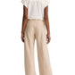 A person stands facing away, wearing a short-sleeve white blouse and the Colette Linen Bias Pant by vince—wide-leg, beige trousers made from luxurious Italian linen with a hidden elastic waistband—set against a white background.