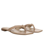 The Vince San Juan Leather Thong Sandal is shown on a white background, featuring beige leather with thin straps, square toes, and a padded footbed.
