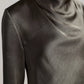 Close-up of a person wearing the Vince Long Sleeve Draped Cowl Blouse in dark gray, featuring a softly draped and pleated neckline.