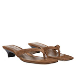 The Vince San Juan Suede Heeled Thong Sandal features brown suede construction with a chic thong silhouette, low block kitten heels, square open toes, and wide straps, displayed on a plain white background.