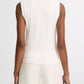 Model wears the vince High V-Neck Shell Tank, a sleeveless white top, paired with matching white pants. Shown from the back against a plain background.