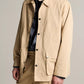 A person wearing the Vince Lightweight Barn Jacket in beige peached cotton with matching trousers over a dark shirt, standing against a neutral background.