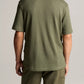 A person is shown from behind wearing the vince Pointelle Short Sleeve Button Down in olive green, paired with matching pants against a plain background.