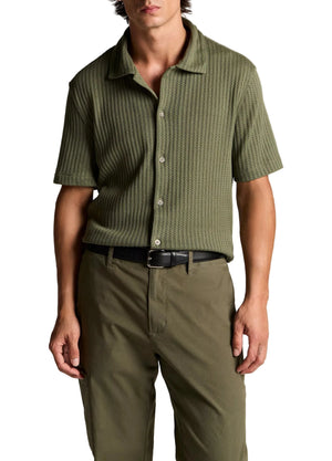 A man is wearing the vince Pointelle Short Sleeve Button Down in olive green with khaki pants, standing with his arms relaxed at his sides.
