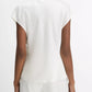 A person stands facing away, wearing the Vince Cowl Neck Cap Sleeve Silk Blouse in white, paired with matching white pants against a plain white background.