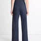 A person shown from the back against a plain background wears the vince Colette High Waist Pant—navy, wide-leg crepe pants with an elastic waistband—paired with a sleeveless black top, capturing the effortless style of the design.