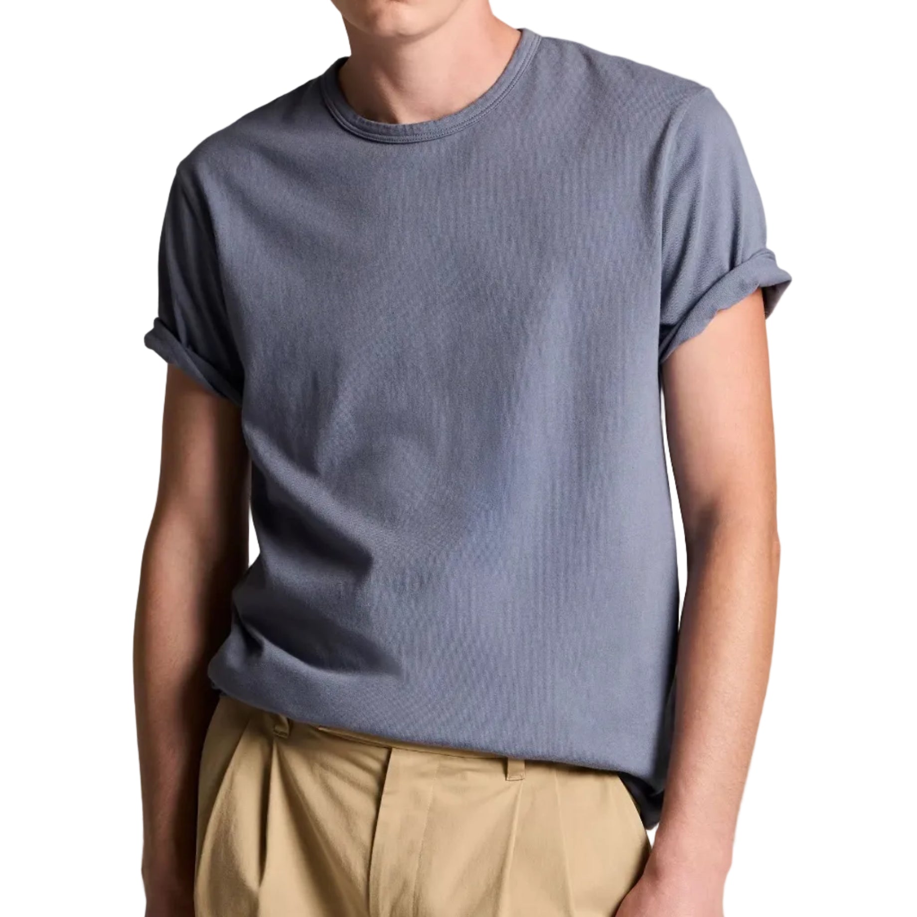 A person wearing the vince Garment Dye S/S Crew, an ultra-soft gray short-sleeve cotton jersey tee with rolled-up sleeves, paired with tan pants, stands against a white background. Their face is partially out of frame.