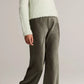 A person wearing a fuzzy light sweater, the Vince Colette High Waisted Fluid Satin Bias Pant, and cream pointed shoes stands against a plain background.