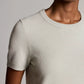 A person wearing the Vince Relaxed Short Sleeve Crew Sweater in light beige, shown from the shoulders to mid-torso against a neutral background.